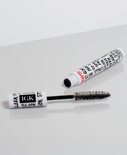 XL Taming Wand with black brush and white cylindrical container on a light gray background